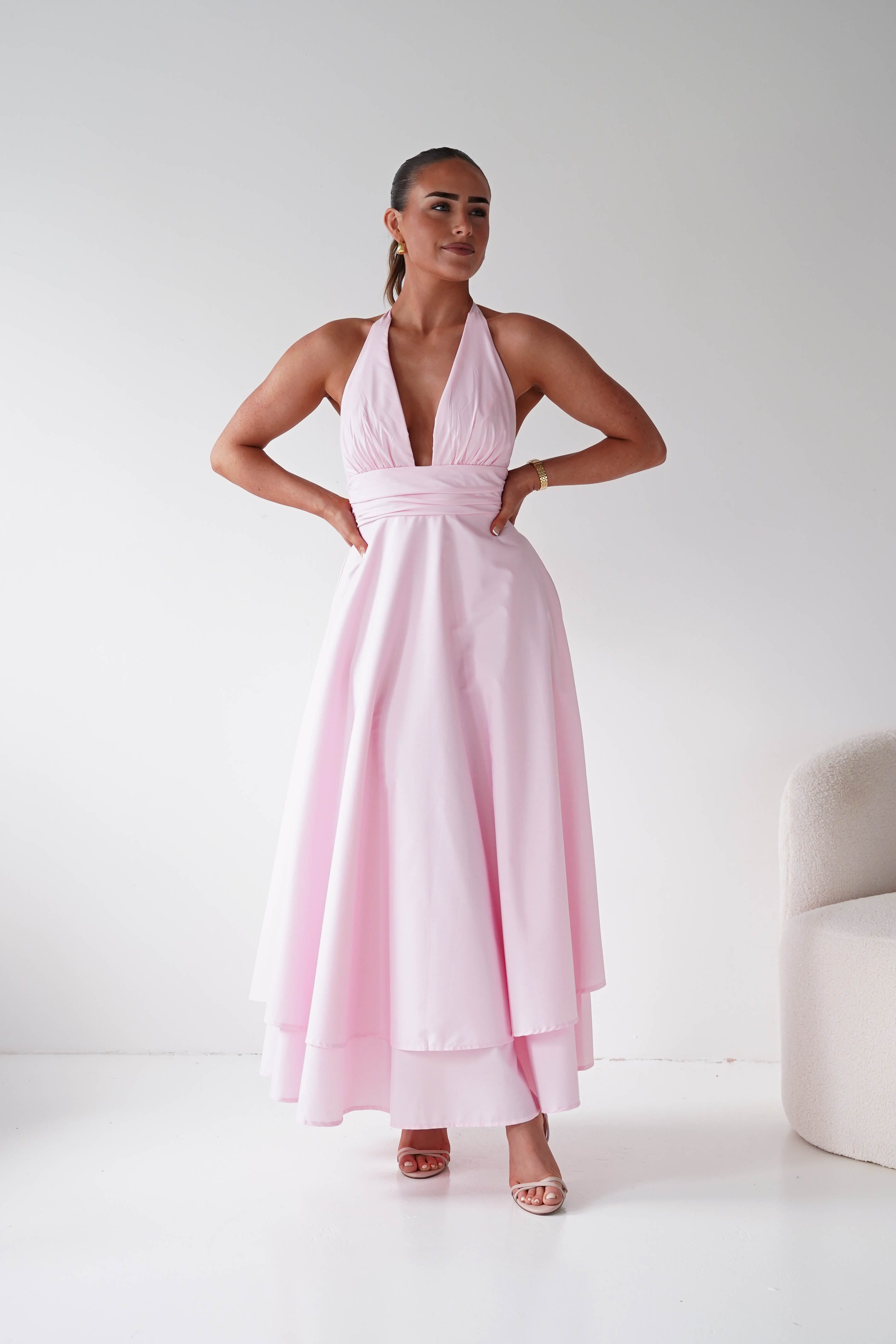 Women wearing a stunning wedding guest dress in the colour pink