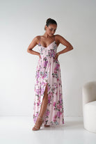 Woman wearing a floral dress with a white background